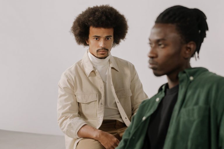 men in casual wear sitting close to each other